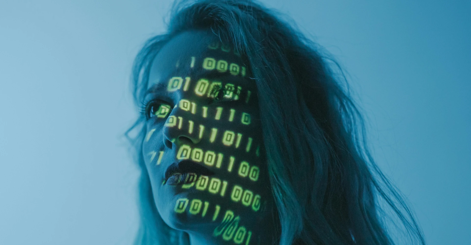 woman with binary code glowing over her face
